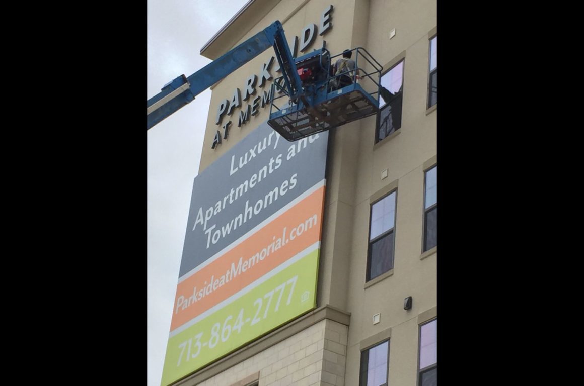 process of installing Parkside wall Id sign